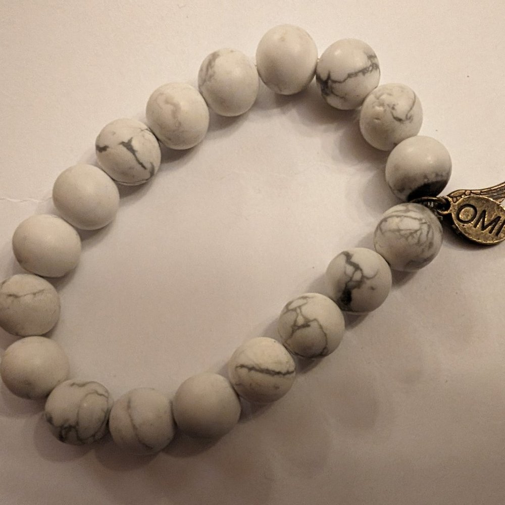 Omi bracelet with semi-precious stones and feather charm.